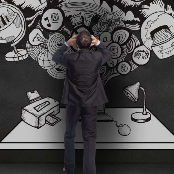 Digital composition of confused businessman looking at graphics on wall