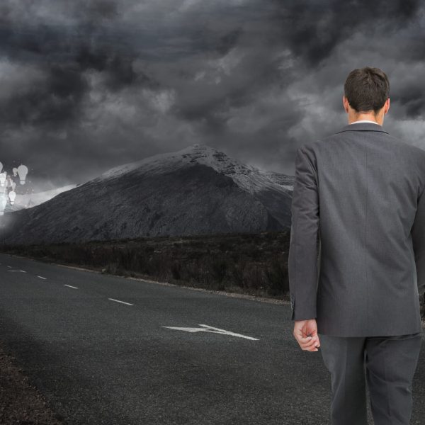 man-walking-along-dark-road