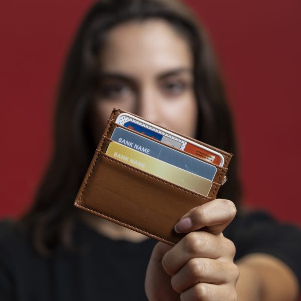 woman-holding-up-her-wallet-close-up