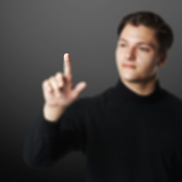 Young businessman background touching invisible screen smart technology